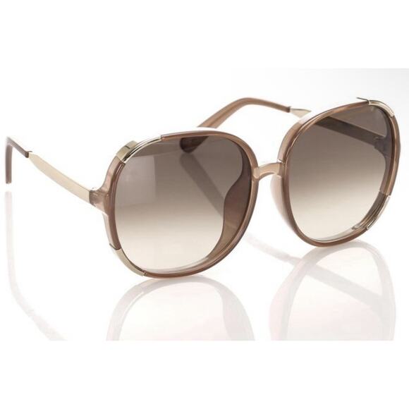 Chloé CE712S sunglasses feature a distinct brown and gold oversized round frame main image 9